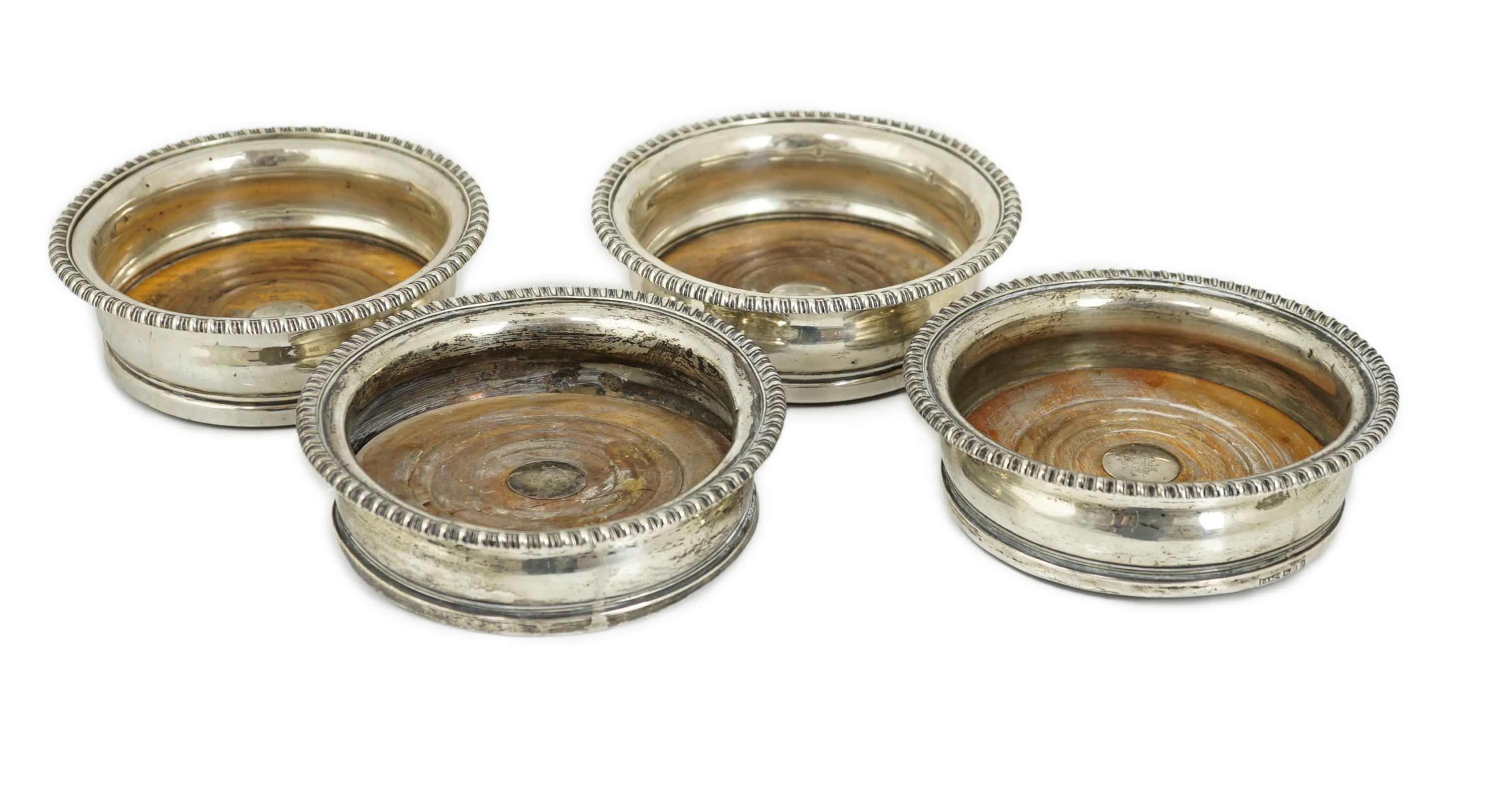 Two pairs of early 19th century silver mounted wine coasters